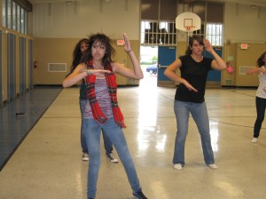 Jaime Stymans and Ashley Stafford practice one of the dances in Maloney Elementary's gym.This picture expesses the rule of thirds, leading lines, diagonals, a repetition of shapes, a peak of emotion, and a depth of field.